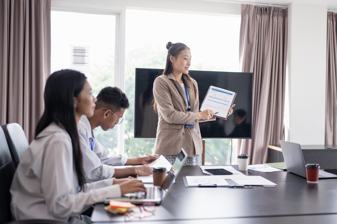 Employees learning on laptops in a training room